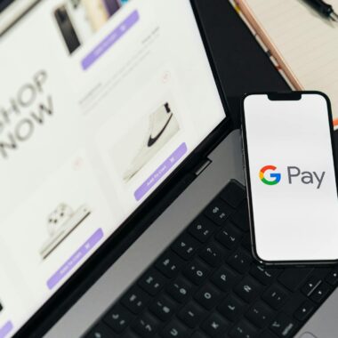 Smartphone with Google Pay on laptop for online shopping convenience.